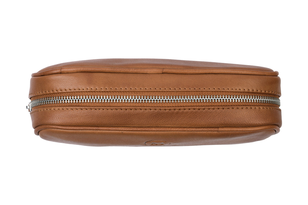 Close-up of YKK zipper on cognac leather toiletry bag