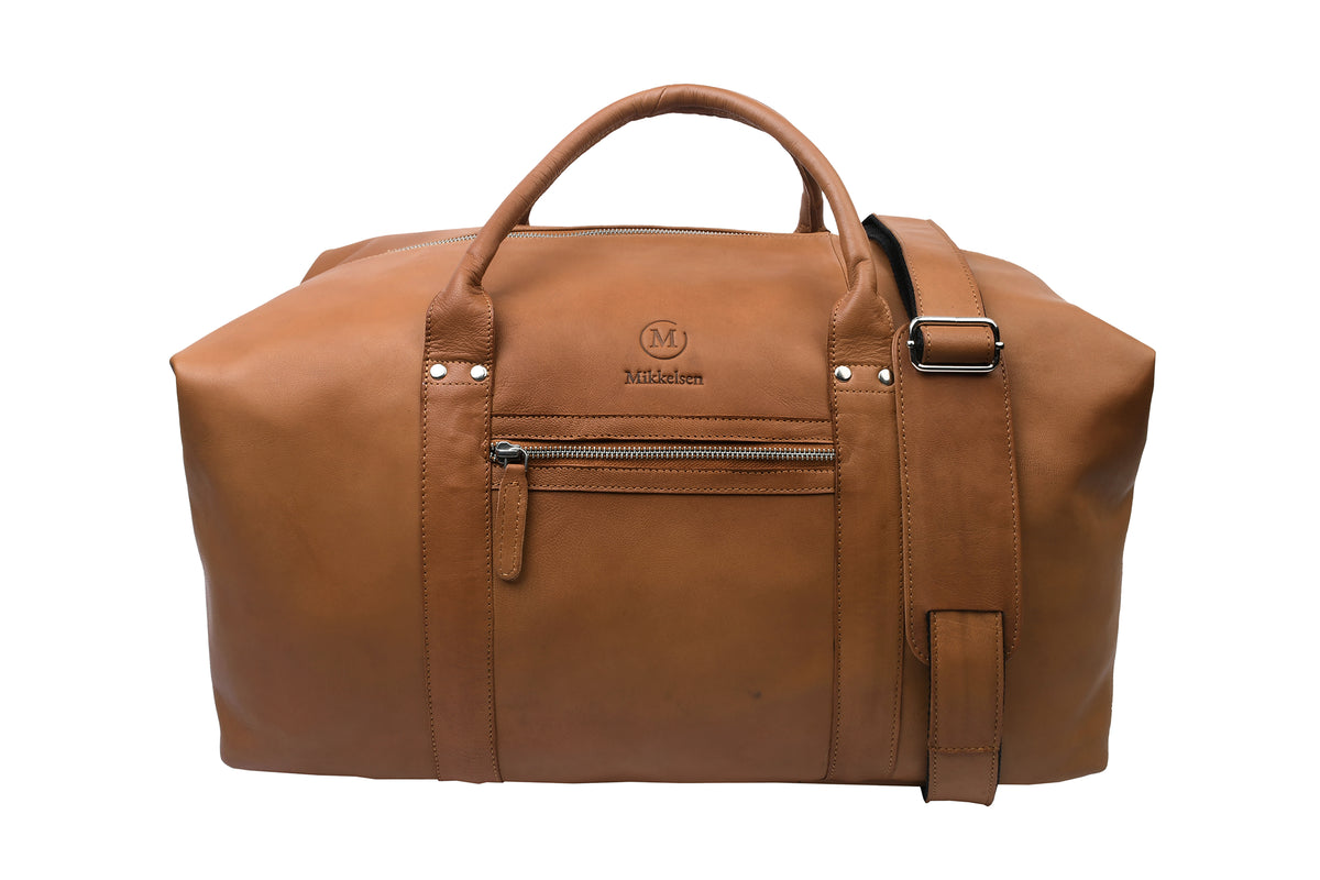 Mikkelsen Copenhagen Cognac Travel Bag, full-grain vegetable-tanned leather weekender with adjustable leather shoulder strap.