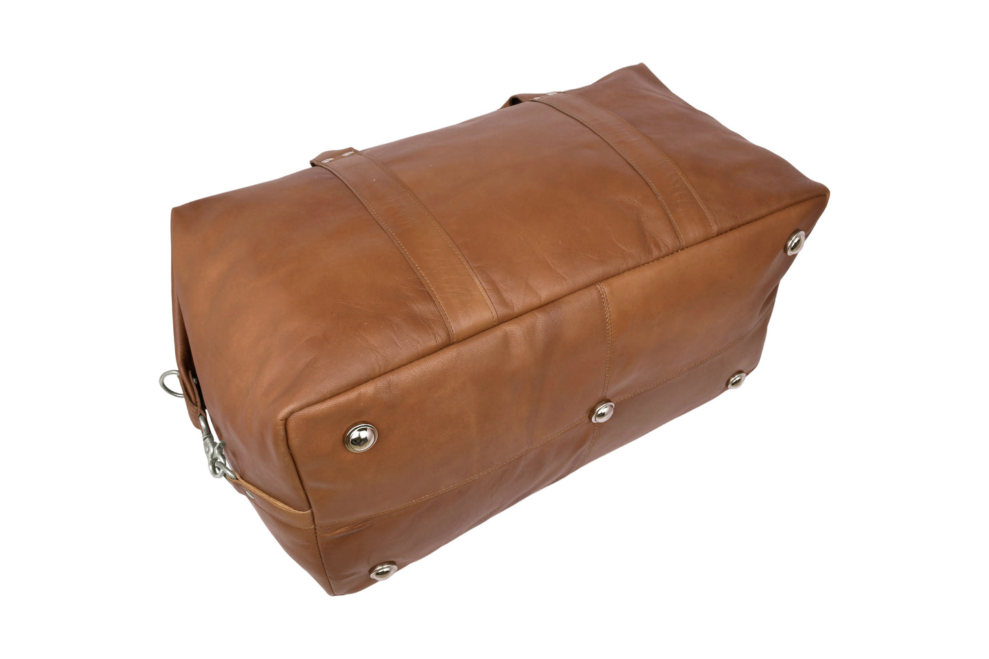 Close-up of bottom studs protecting cognac leather travel bag on hard surfaces.