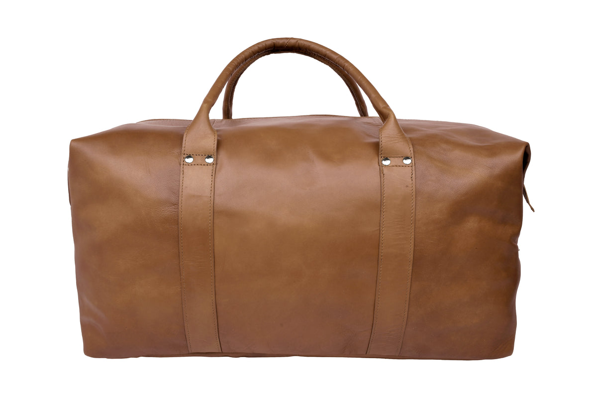Cognac leather travel bag styled in use, Scandinavian travel accessory.