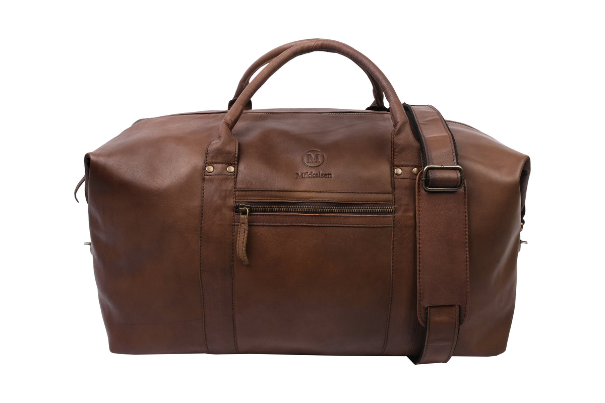 Mikkelsen Copenhagen Dark Brown Travel Bag, full-grain vegetable-tanned leather weekender. With adjustable leather shoulder strap.
