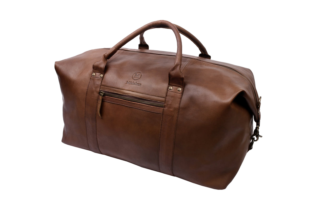 Dark brown leather travel bag front view showing YKK brass zipper and front pocket.