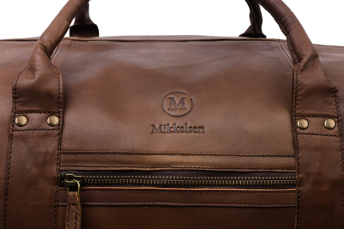 Close-up of cdark brown vegetable-tanned full-grain leather grain and natural patina